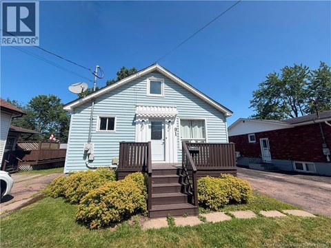 A blue house with a white door and a small porch.