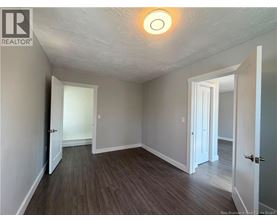 A room with a wooden floor and white walls.