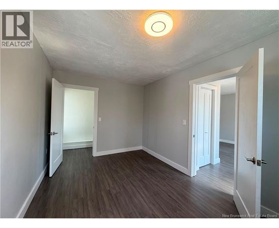 A room with a wooden floor and white walls.