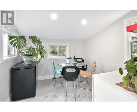 A dining room with a table and chairs.