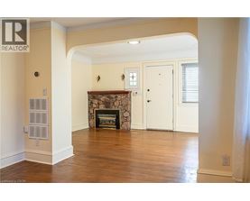 A living room with a fireplace and a white door.