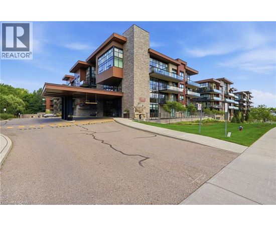 A modern apartment building with a parking lot in front.