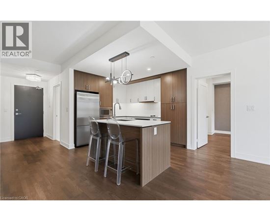 A modern kitchen with wooden cabinets and a central island.
