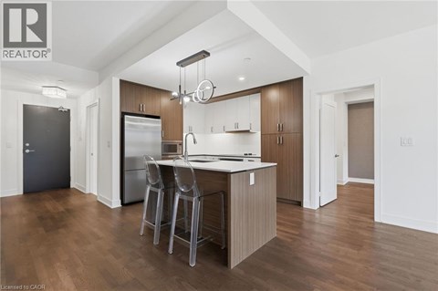 A modern kitchen with wooden cabinets and a central island.