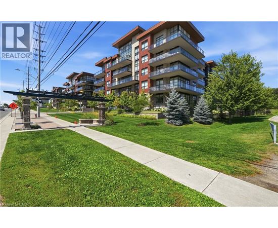 A large apartment complex with a grassy area in front.