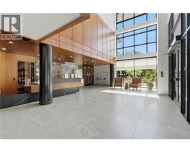 A spacious lobby with a reception desk and a large window.