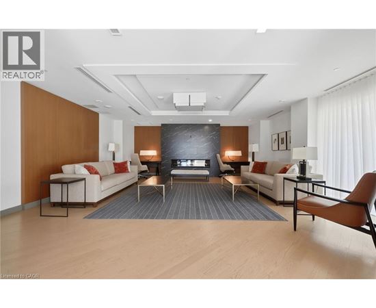 A living room with a white couch, a black coffee table, and a wooden floor.