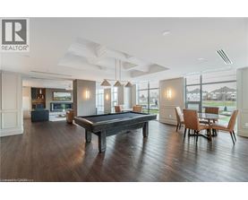 A pool table is in the middle of a room with a wood floor.