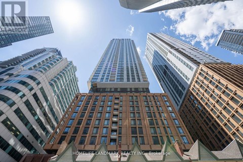 A view of a cityscape with tall buildings and a clear blue sky.