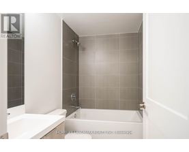 A bathroom with a tub and a shower.