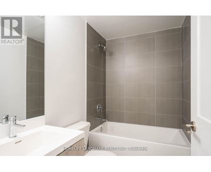 A bathroom with a white sink and a white bathtub.