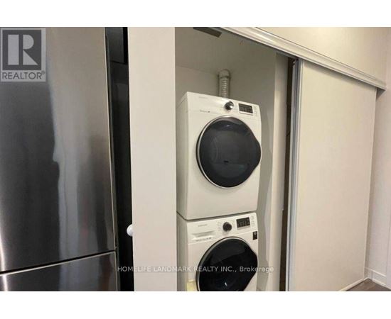 A washer and dryer are stacked on top of each other in a small space.
