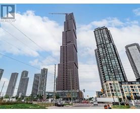A cityscape with a tall building under construction in the foreground.