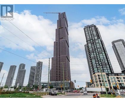A cityscape with a tall building under construction in the foreground.