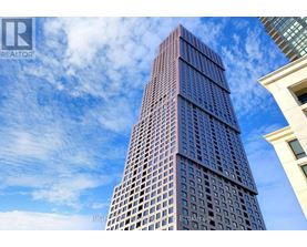 A tall building with a blue sky in the background.