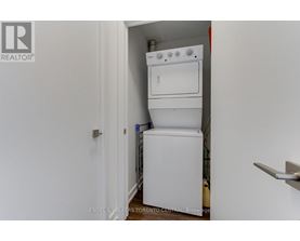 A white dishwasher and oven are installed in a small space.