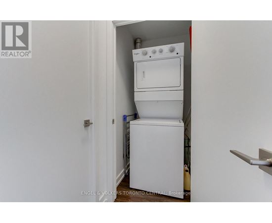 A white dishwasher and oven are installed in a small space.