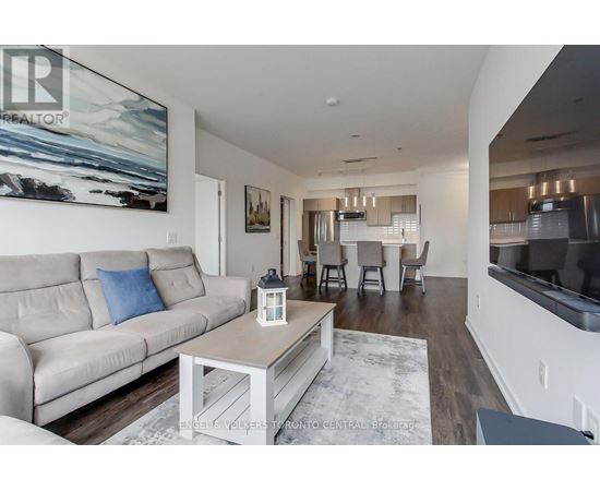 A living room with a beige couch and a coffee table.