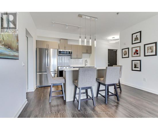 A modern kitchen with a dining table and chairs.
