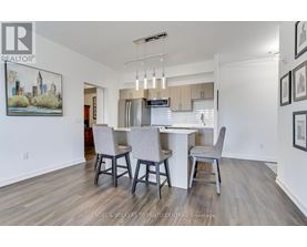 A dining room with a table and chairs.