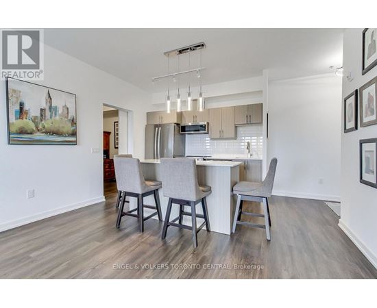 A dining room with a table and chairs.