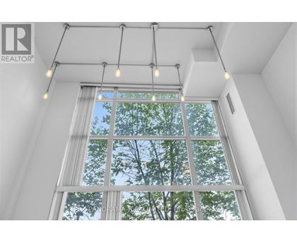 A window with a view of trees and sky.