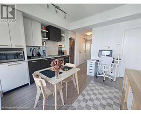 A modern kitchen with a dining table and chairs.