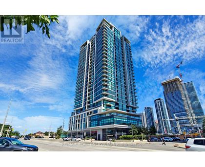 A tall, modern building with many windows is the focal point of the image.