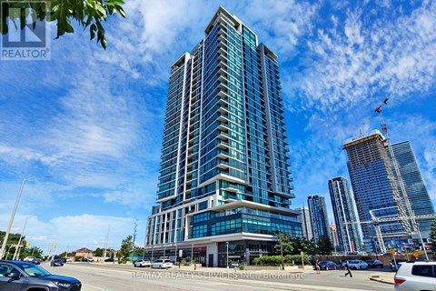 A tall, modern building with many windows is the focal point of the image.