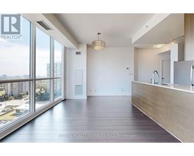 A spacious room with a large window overlooking a cityscape.