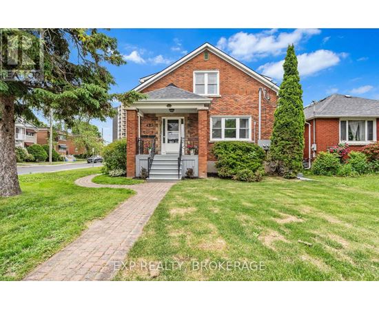 A red brick house with a white door and windows.