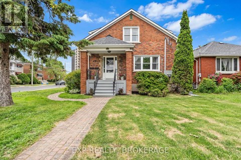 A red brick house with a white door and windows.