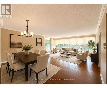 A well-lit dining room with a table set for six.