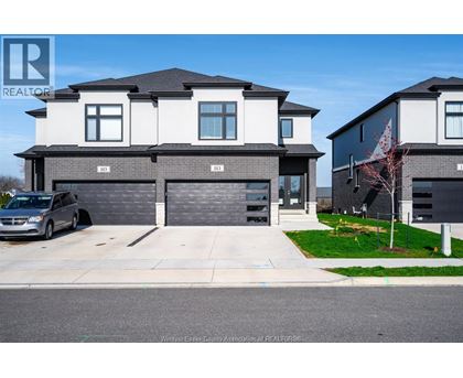A modern two-story house with a garage is shown in the image.
