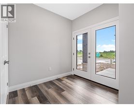 A room with a wooden floor and a sliding glass door.