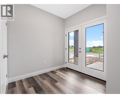 A room with a wooden floor and a sliding glass door.