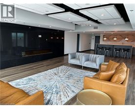 A modern living room with a fireplace and a large rug.