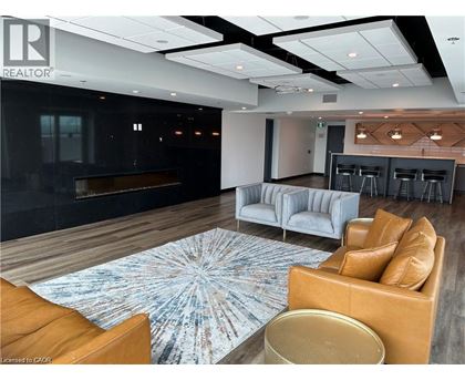 A modern living room with a fireplace and a large rug.