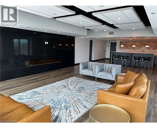 A modern living room with a fireplace and a large rug.