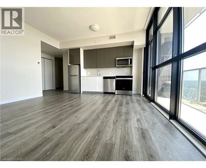 A spacious kitchen with a refrigerator, oven, and microwave.