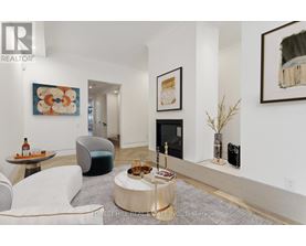 A living room with a white couch and a coffee table.
