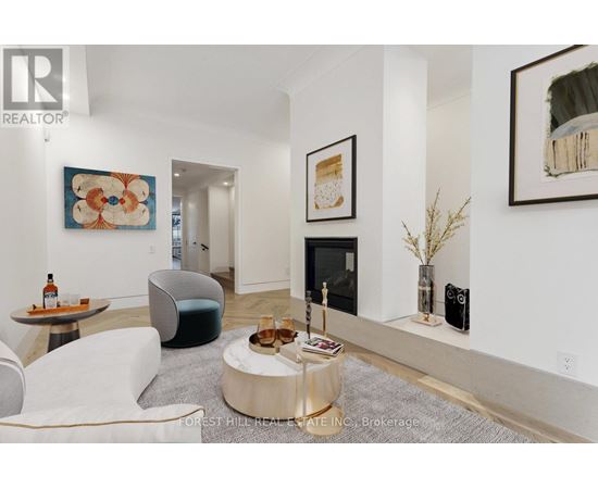 A living room with a white couch and a coffee table.
