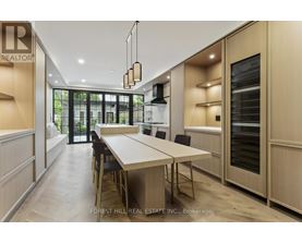 A modern kitchen with a dining table and chairs.