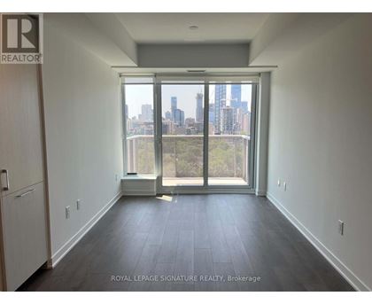 A room with a view of the city skyline through a large window.