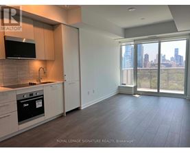 A kitchen with a microwave, oven, and cabinets.