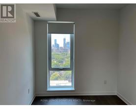 A room with a large window showing a cityscape outside.