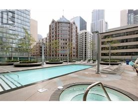 A pool area with a slide in the middle of a city setting.