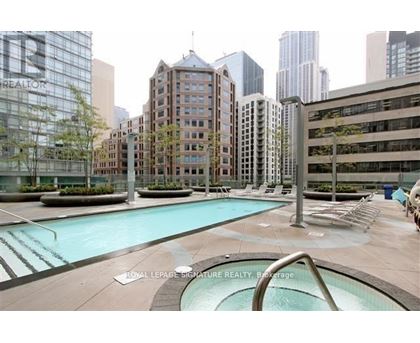 A pool area with a slide in the middle of a city setting.