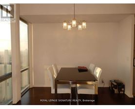 A dining room with a table and chairs.