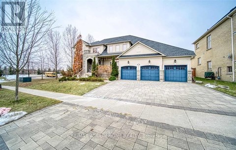 A large house with a brick chimney and a driveway in front.